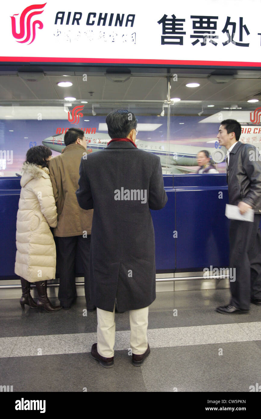 Beijing, travelers at a counter of Air China Stock Photo