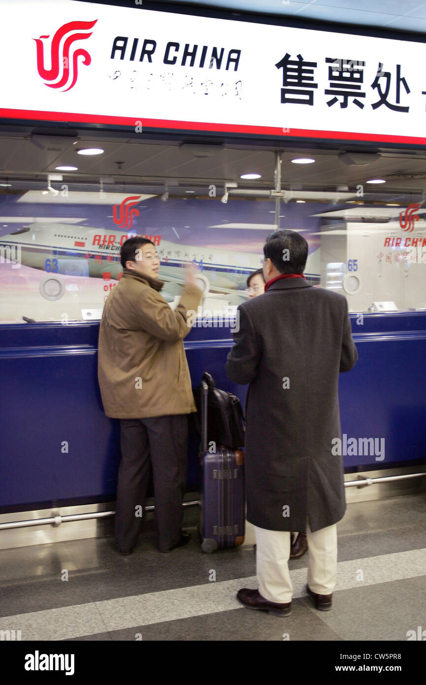 Beijing, travelers at a counter of Air China Stock Photo