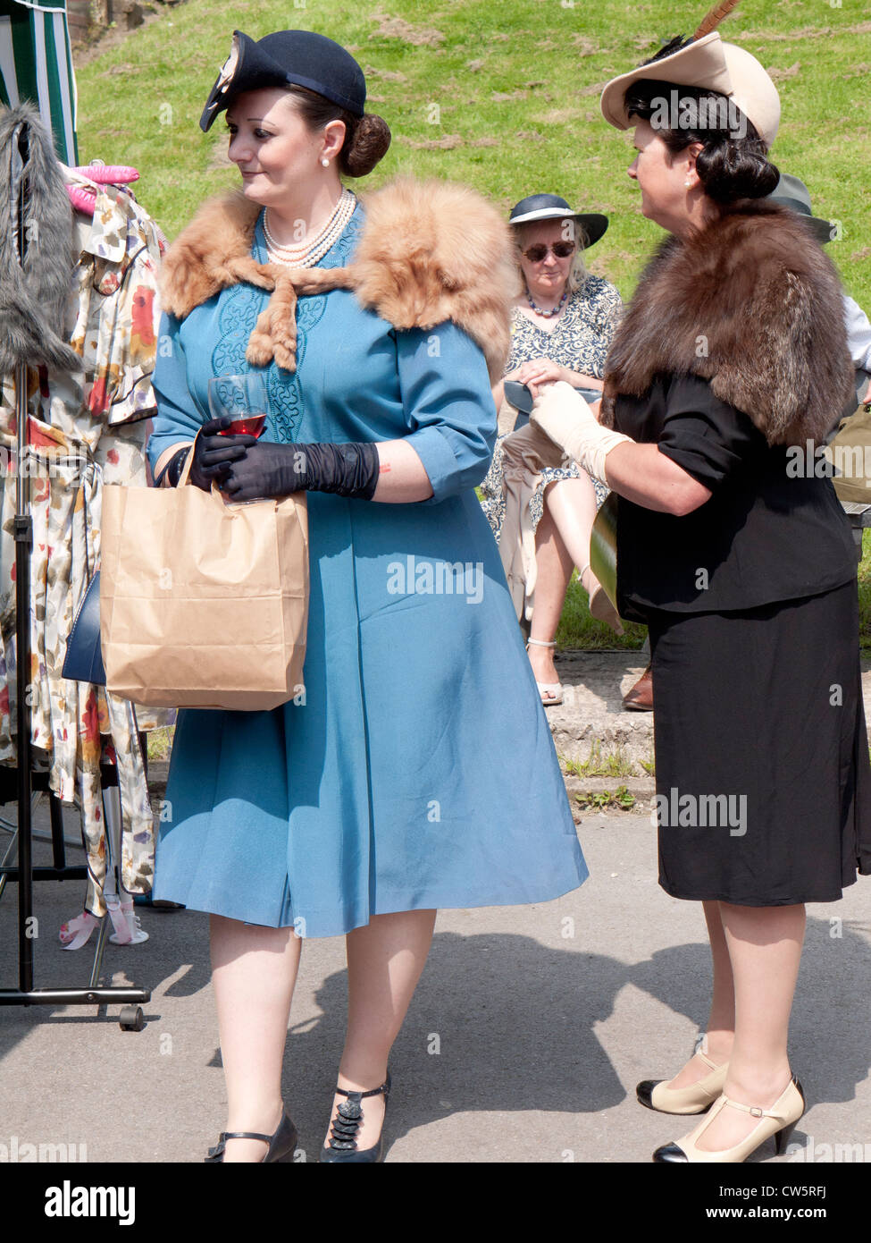Two women dressed in 1940s clothes shopping, reenactment weekend at