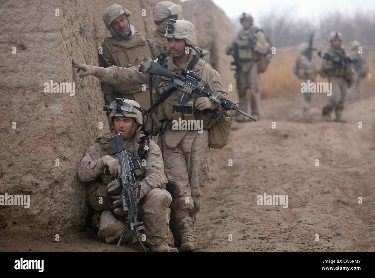US Marines investigate a possible improvised explosive device while on a patrol February 2, 2010 in Helmand province, Afghanistan. Stock Photo