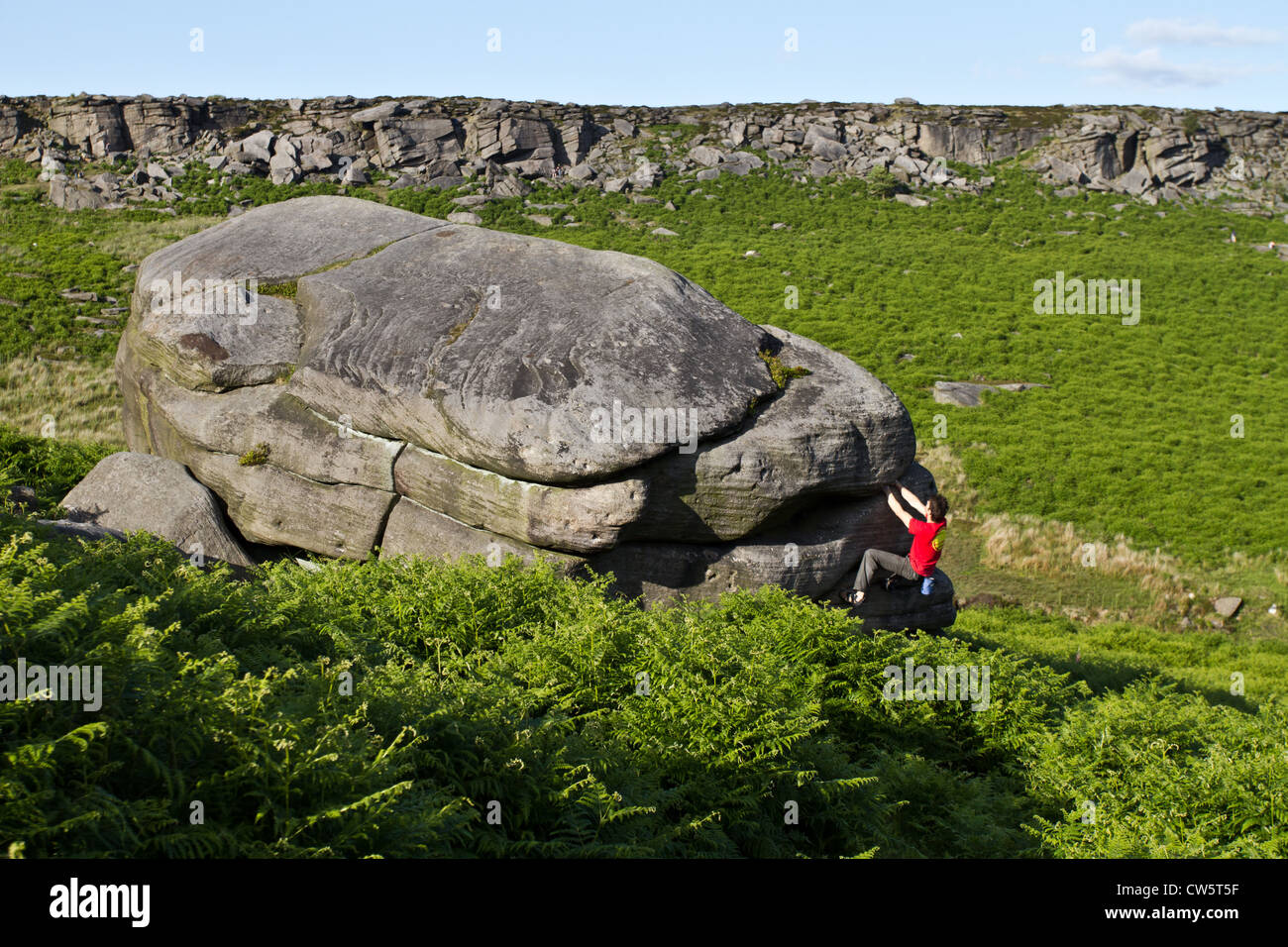 Tom Randall rock climbs a crack at Burbage in Sheffield near Stanage on the Peak District National Park Derbyshire, England Stock Photo