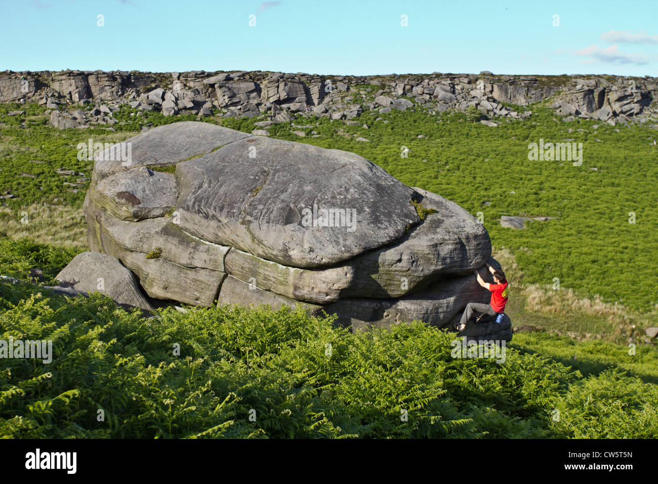 Tom Randall rock climbs a crack at Burbage in Sheffield near Stanage on the Peak District National Park Derbyshire, England Stock Photo