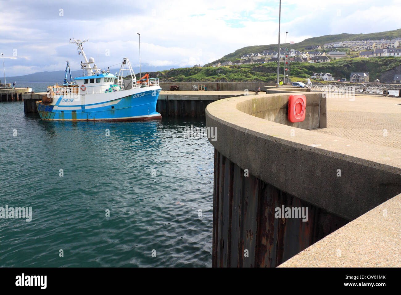 Fishing boat by the harbour wall in Mallaig, west coast of Scotland Stock Photo