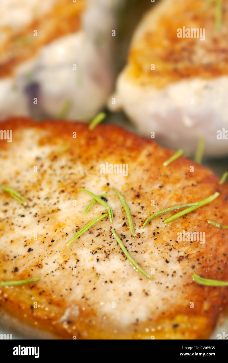 Seasoned boneless pork chops pan seared with rosemary Stock Photo Alamy