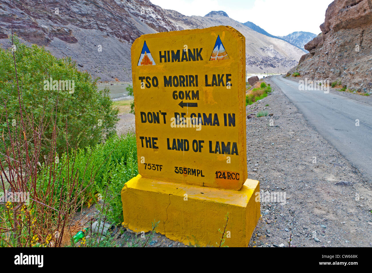 A yellow cautionary road sign that reads Don't Be Gama in the Land of Lama on the Leh-Manali Highway Ladakh, India Stock Photo