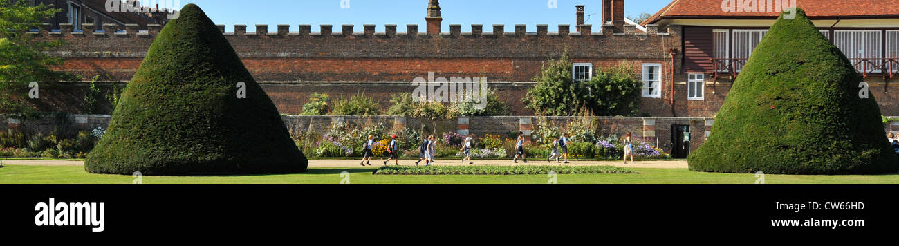 Panoramic widescreen shot of children walking through gardens at hampton court ,  south west london, england Stock Photo