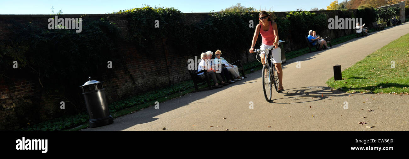 Panoramic widescreen shot of cyclists riding through hampton court , south west london, england Stock Photo