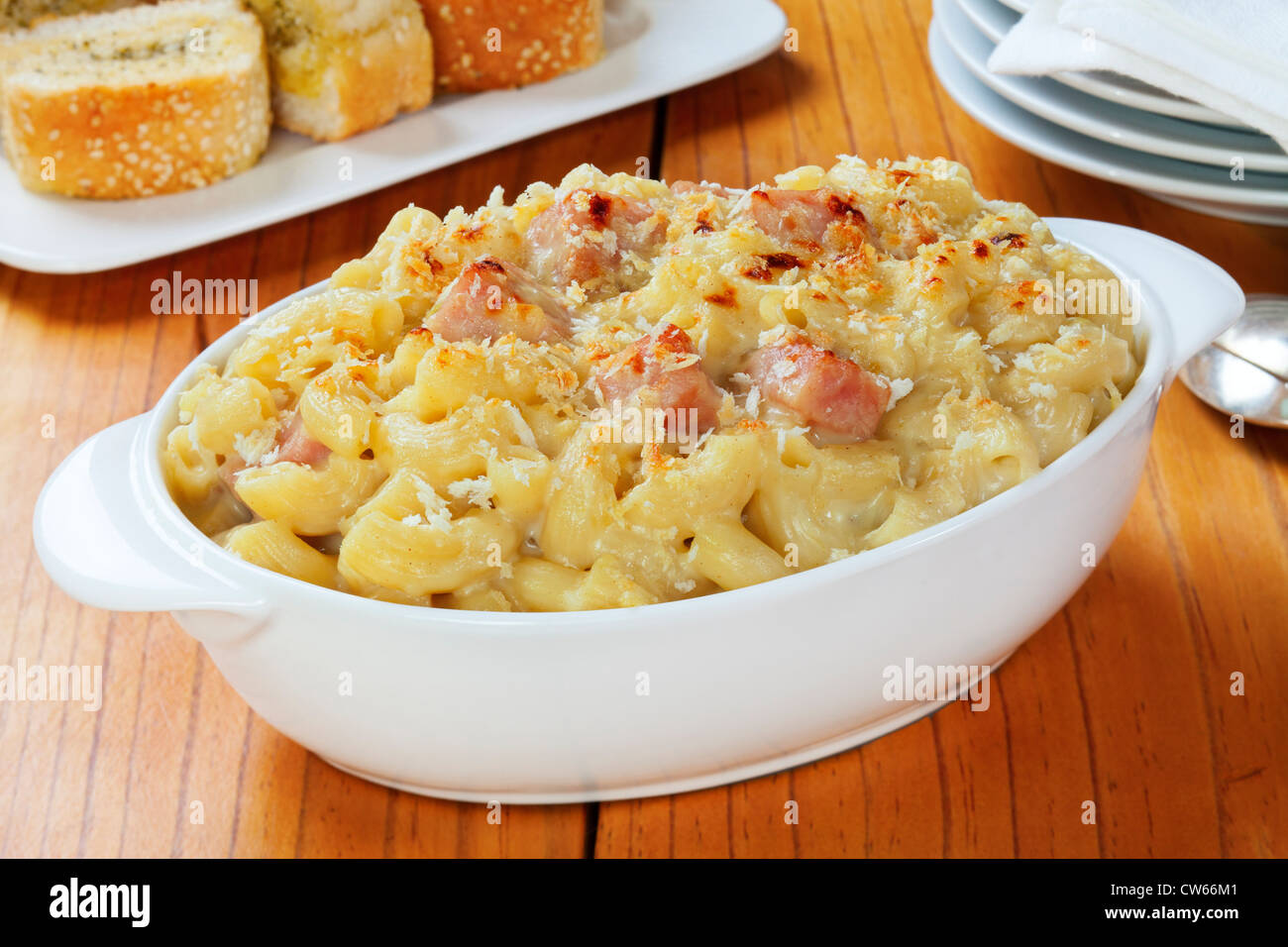 Macaroni Cheese with ham, served with garlic bread. A great way to use