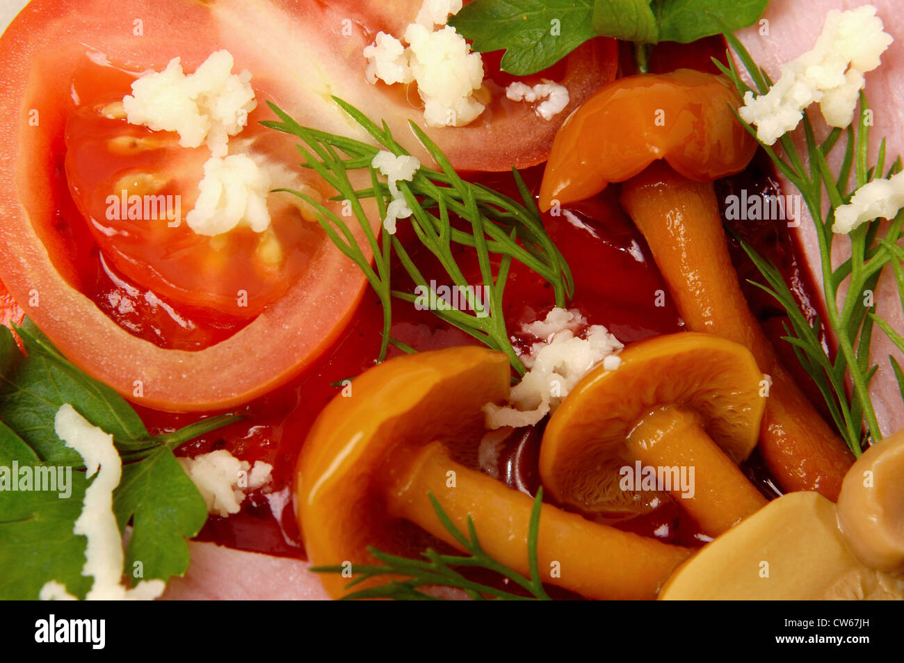 mushrooms, ham and tomatoes covering pizza Stock Photo