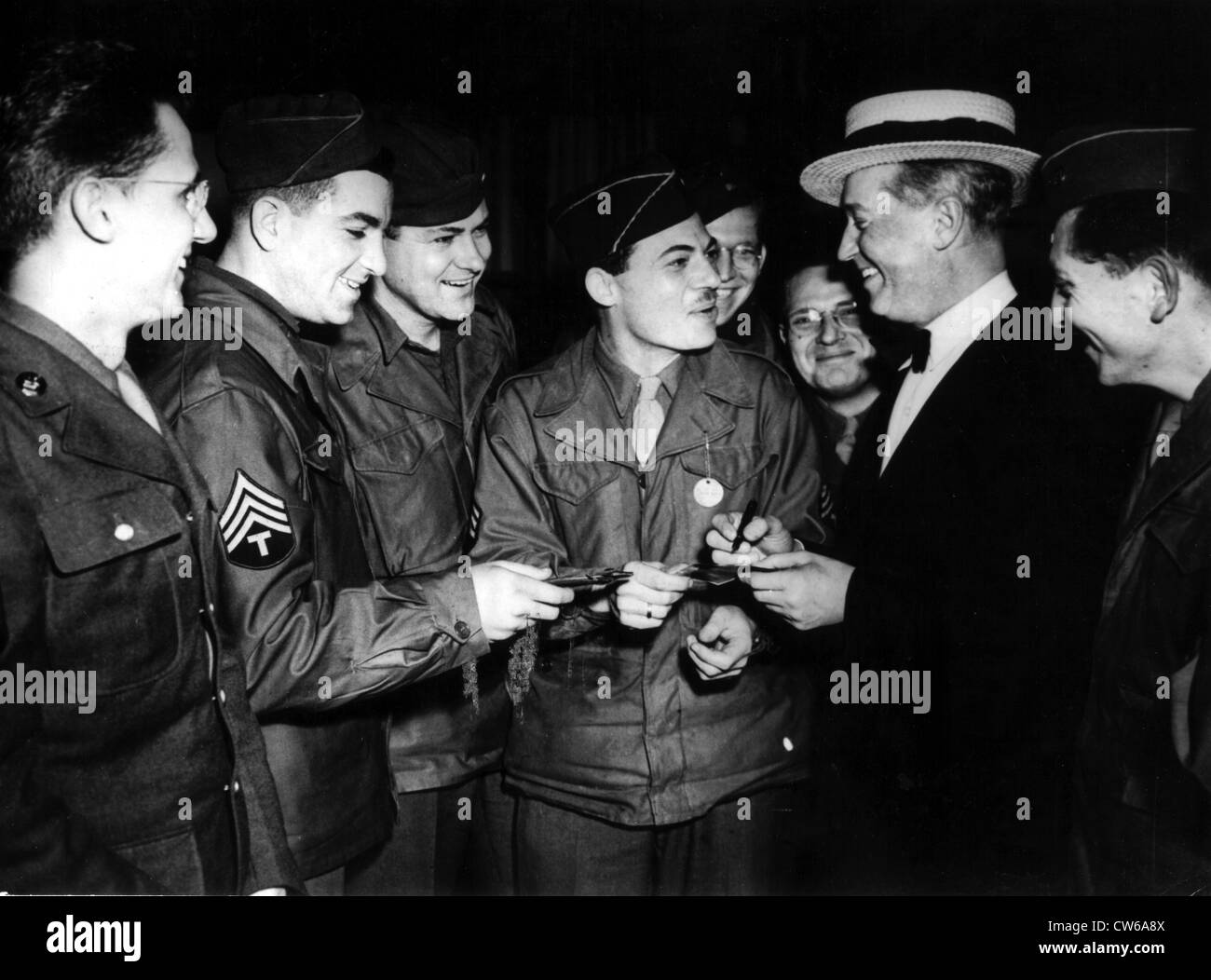 Maurice Chevalier signs autographs for U.S soldiers at Marseille (France) 1945 Stock Photo