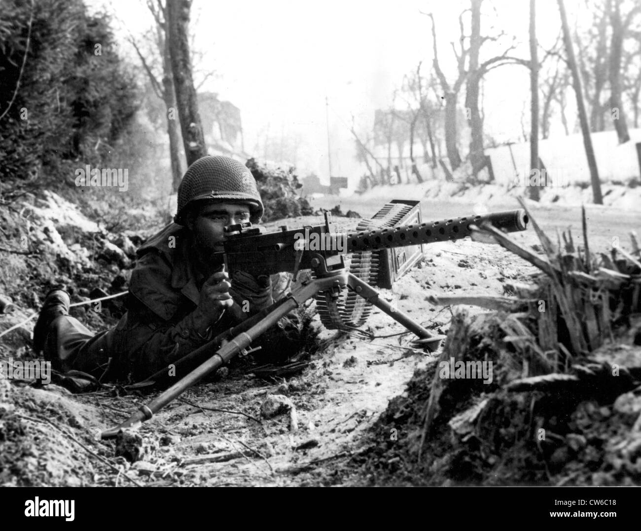 U.S machine gunner guards road in France, Fall 1944 Stock Photo
