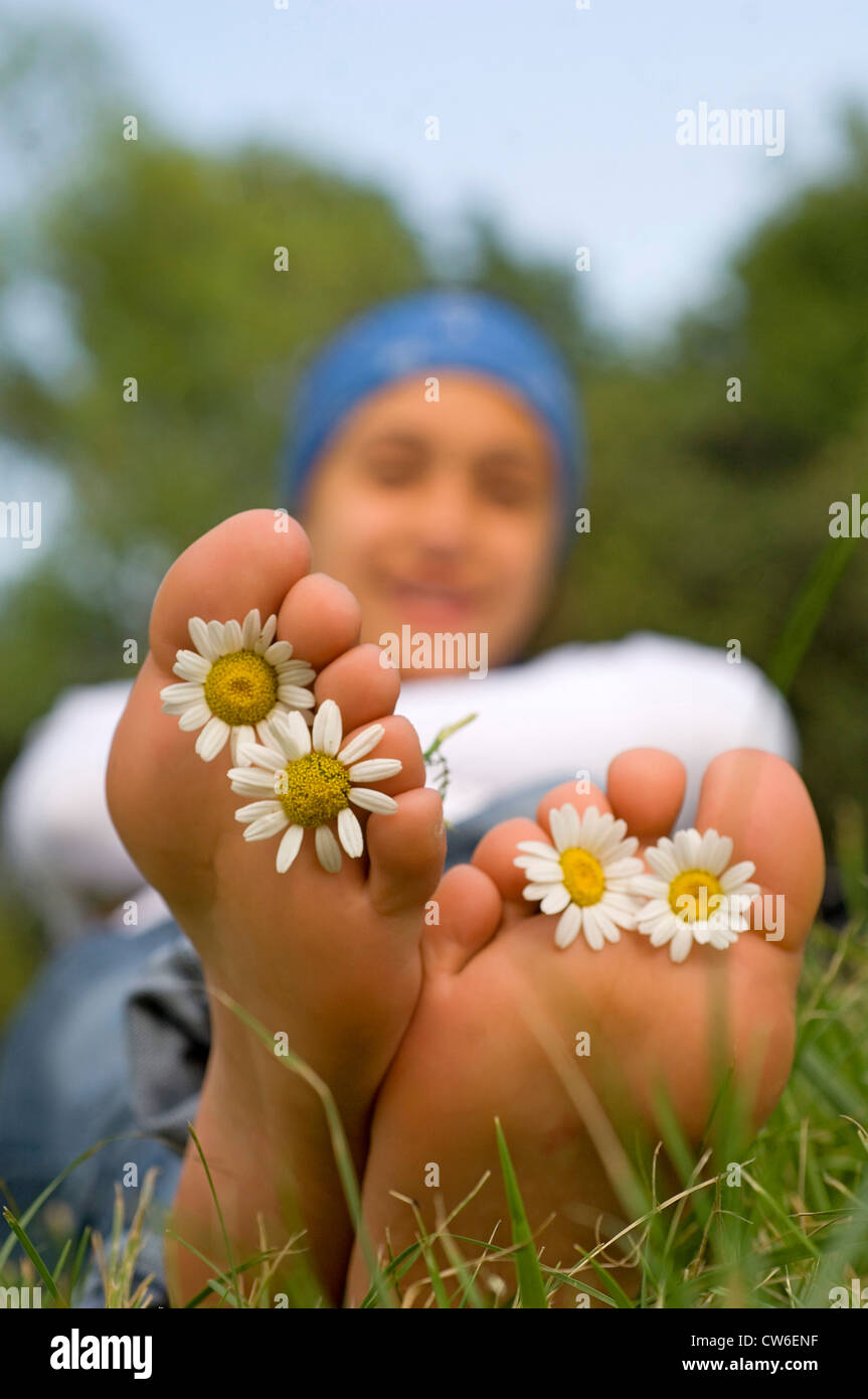 feet with flowers between the toes Stock Photo