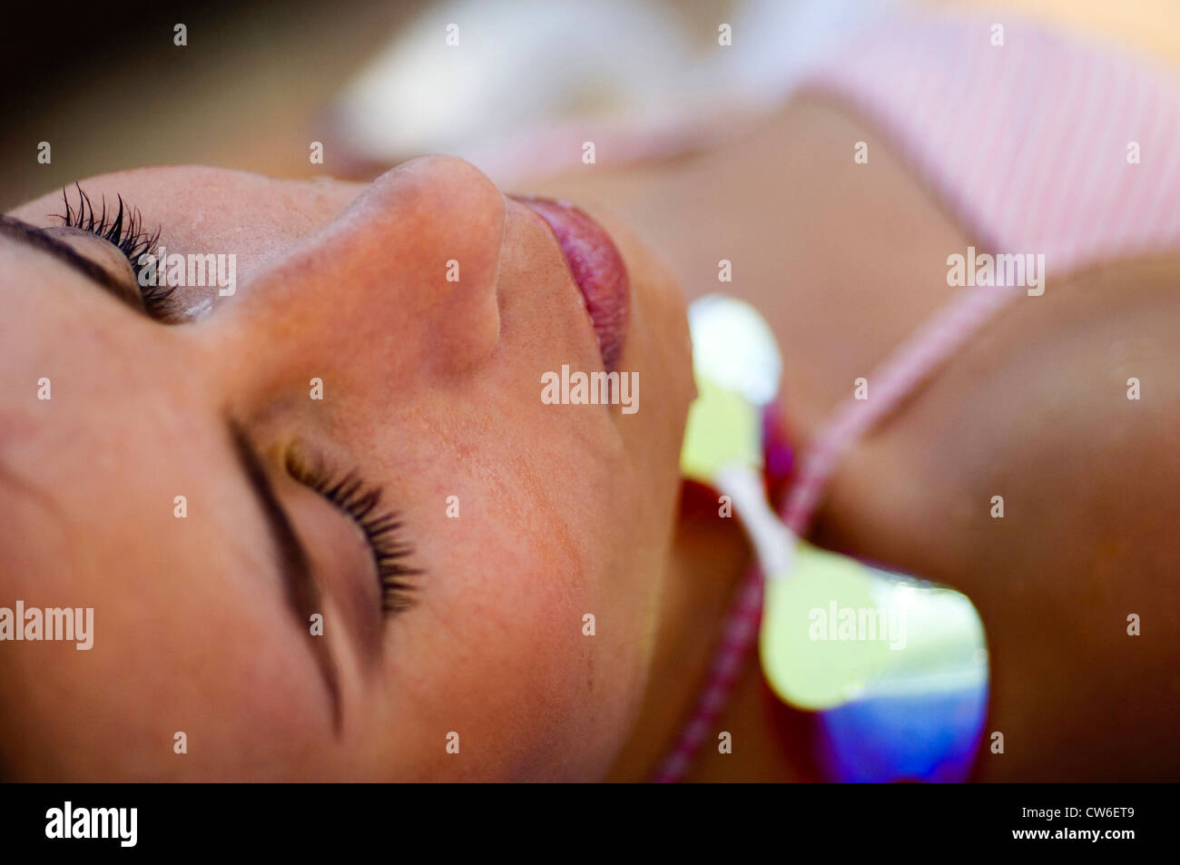young woman relaxing at a swimming pool Stock Photo