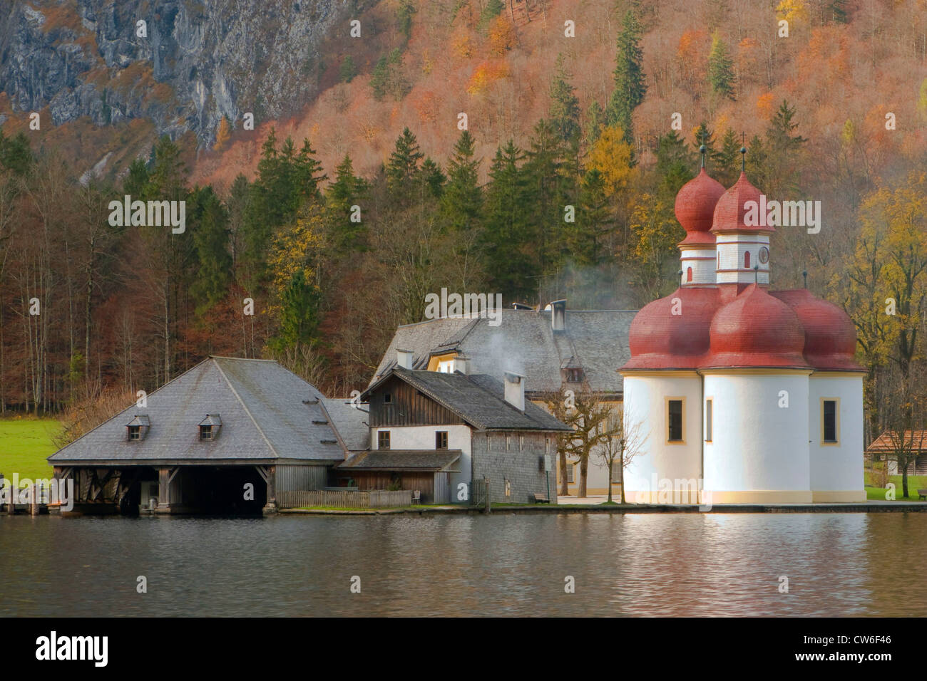 St. Bartholomae at the lake in front of autumn forest, Germany, Bavaria, Koenigssee Stock Photo