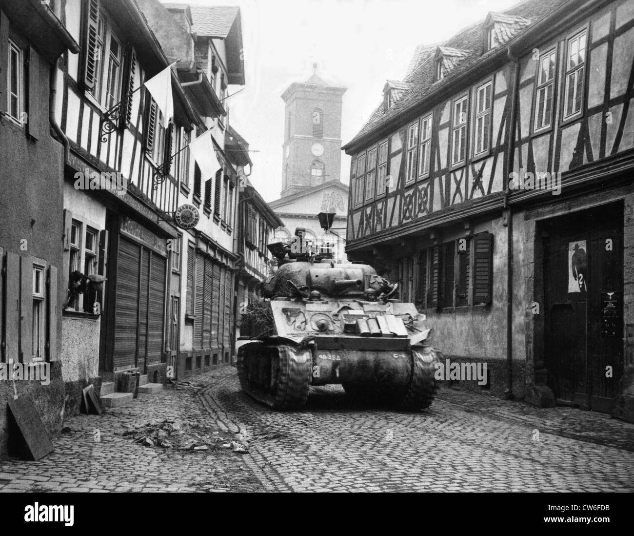 American tank rumbles beneath white flags in Hanau (Germany) March 28, 1945 Stock Photo