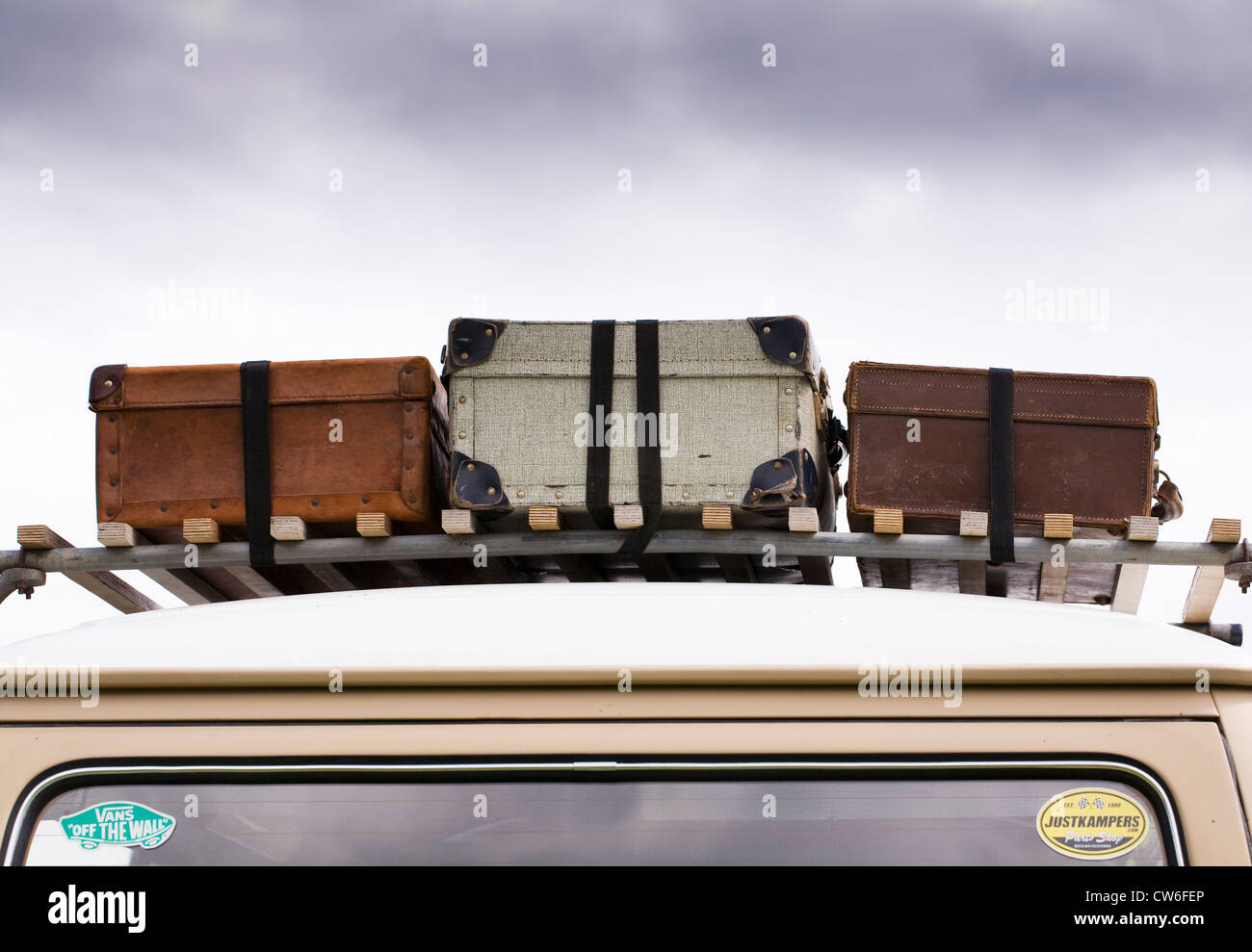Three old suitcases on an old VW campervan. Stock Photo