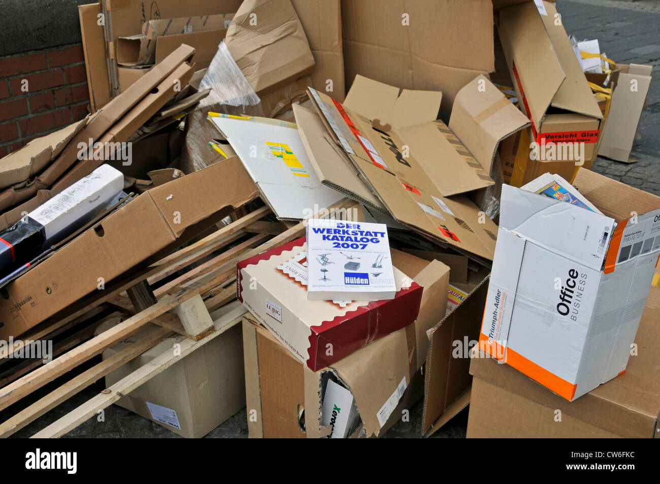 paperboard containers, plywood and paper on sidewalk, Germany Stock