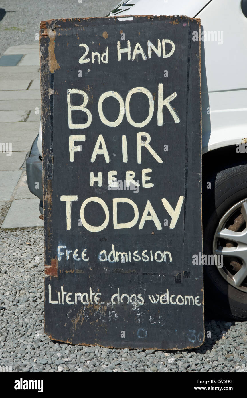 Close up of secondhand books used outside book fair sign signage England UK United Kingdom GB Great Britain Stock Photo