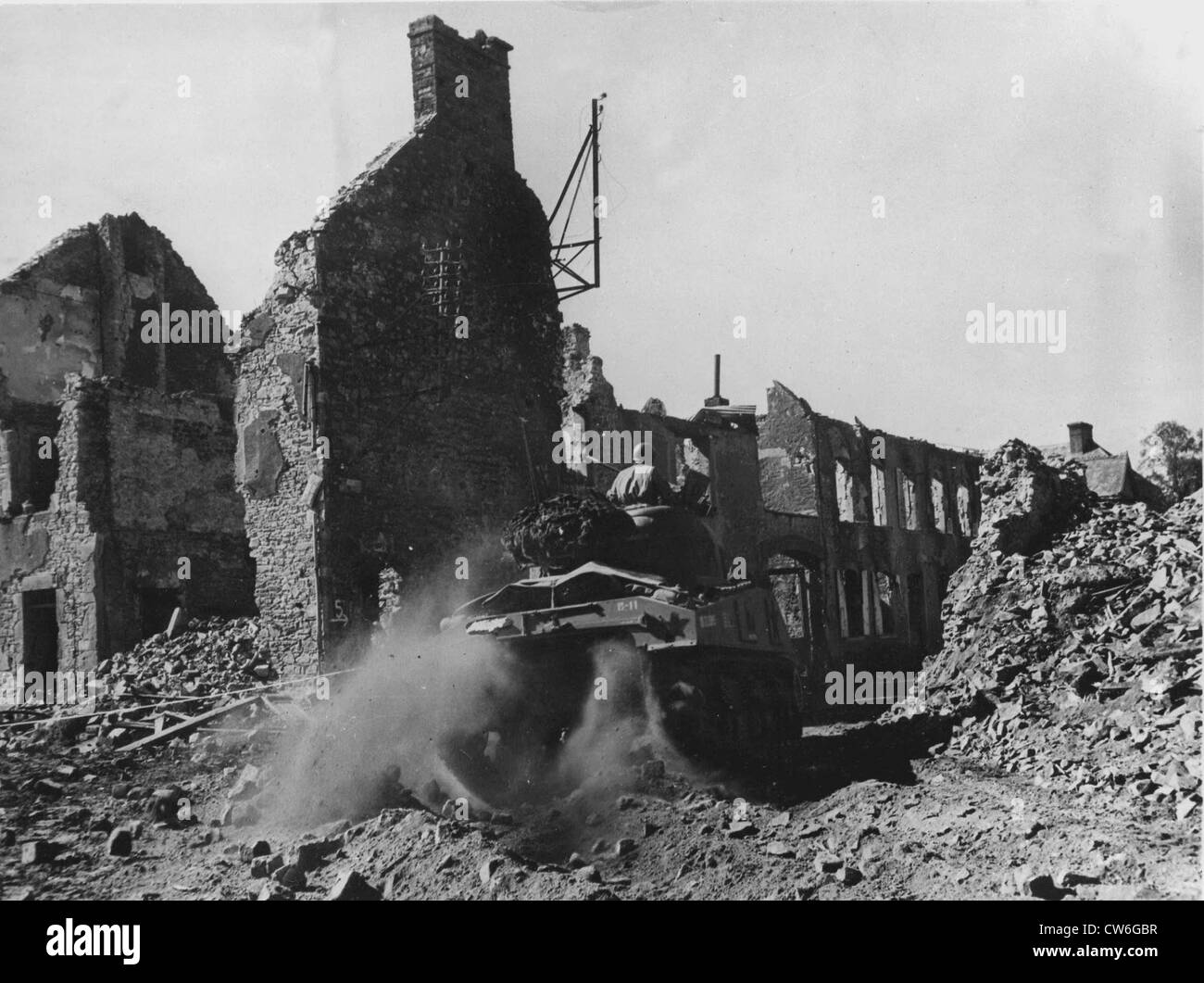 A M-4 Sherman tank crossing the town of Périers, heading towards Coutances Stock Photo