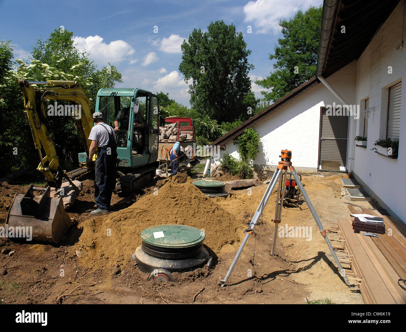 installing of cisterns for rainwater near a house, Germany, North Rhine-Westphalia, Weilerswist Stock Photo