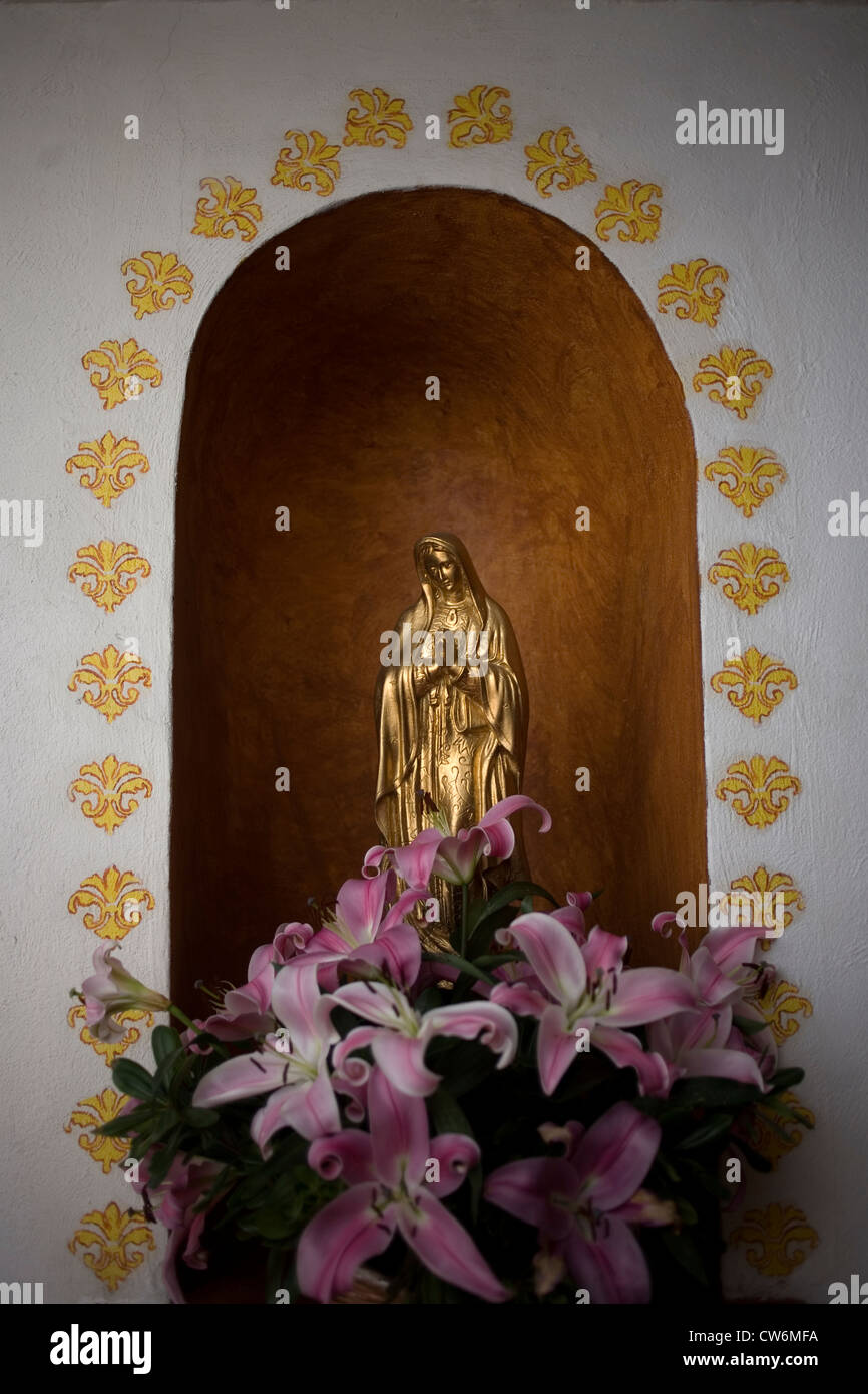 A golden sculpture of the Our Lady of Guadalupe is displayed in Casa de los Frailes hotel in Oaxaca, Mexico, July 7, 2012. Stock Photo