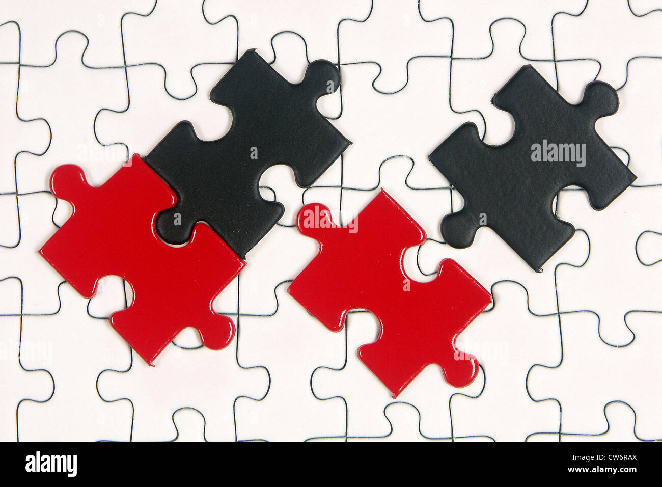 puzzle with red and black pieces Stock Photo - Alamy