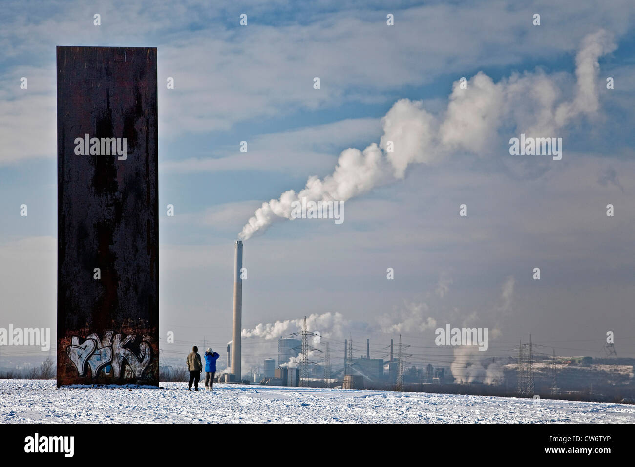 two persons at the modern sculpture on the stockpile Schurenbach in winter, Germany, North Rhine-Westphalia, Ruhr Area, Essen Stock Photo