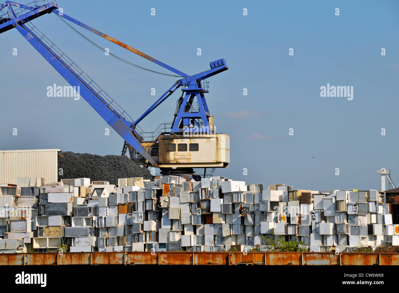 discarded refrigerator with gantry crane on a metall scrap the inner harbour, Germany, North Rhine-Westphalia, Ruhr Area, Duisburg Stock Photo