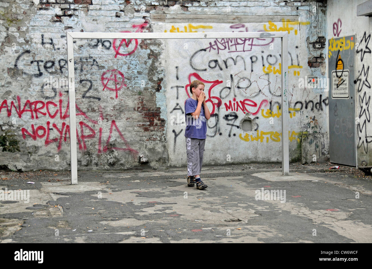 boy on a football area with graffiti, Germany, North Rhine-Westphalia, Cologne Stock Photo