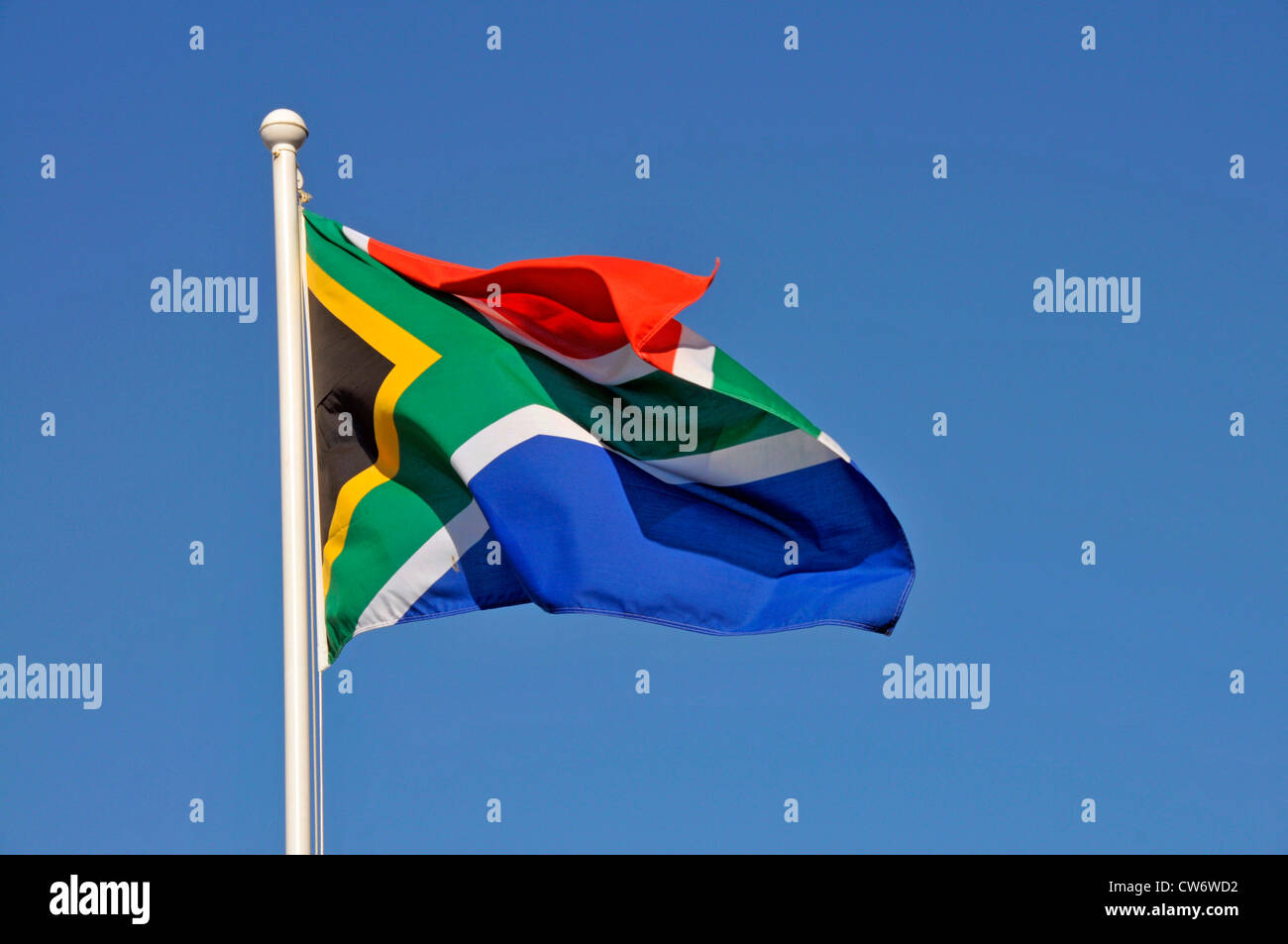 national flag of Southafrica waving in the wind in front of a clear blue sky, South Africa Stock Photo