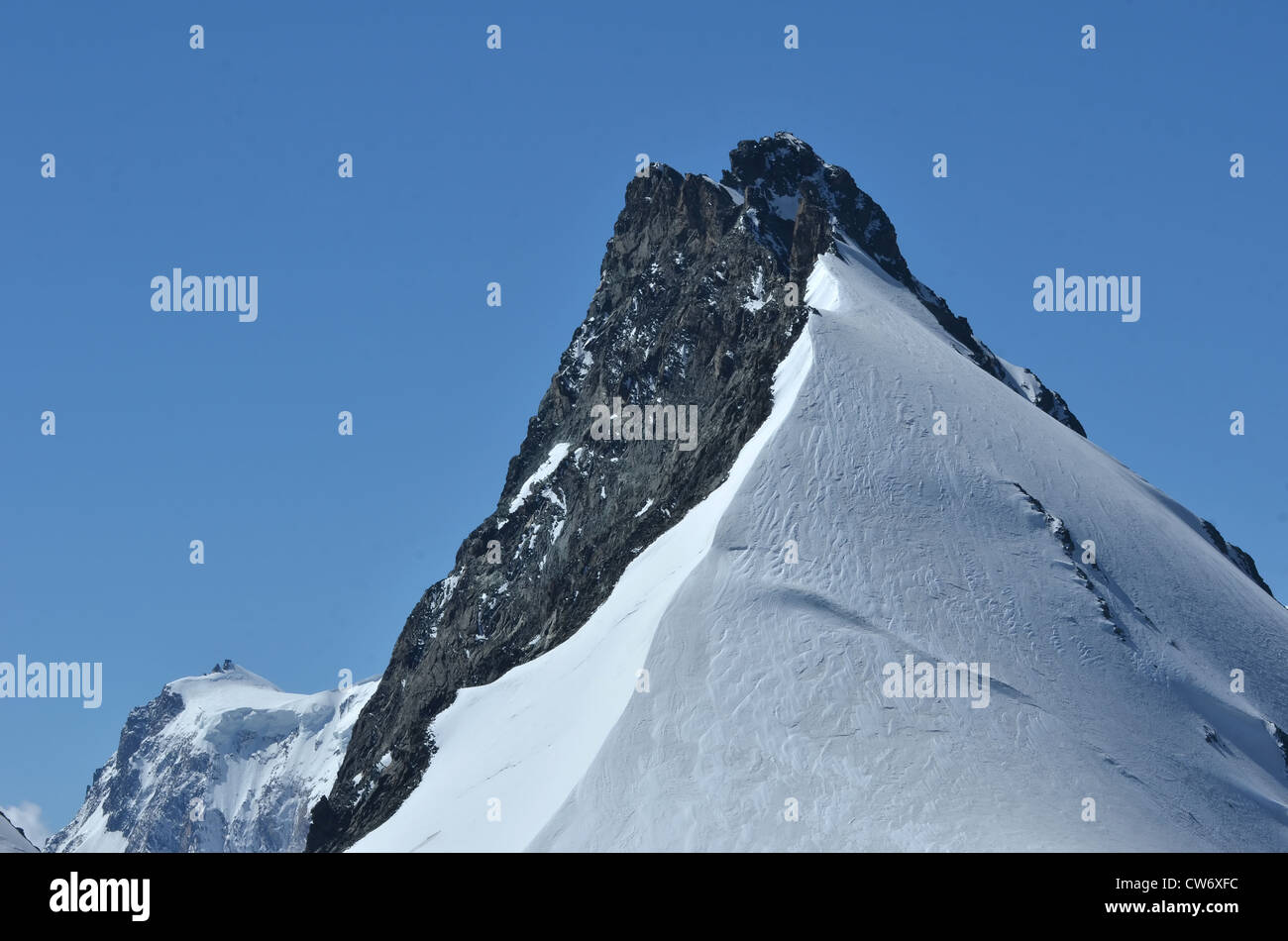 the summit and north ridge of the Rimpfishchhorn showing knife edge ridge route to the summit. In the southern swiss alps betwee Stock Photo