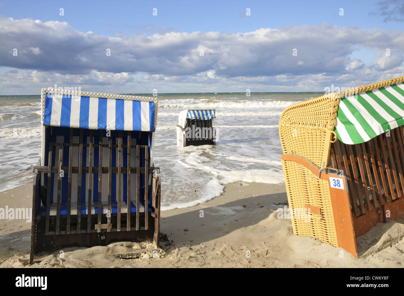 beach chairs at the sand beach, some standing in the surf, Germany, Mecklenburg Vorpommern, Ostsee Stock Photo