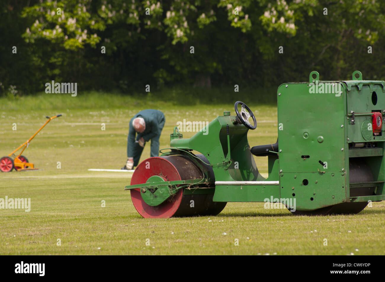 Groundsman preparing village cricket pitch Stock Photo