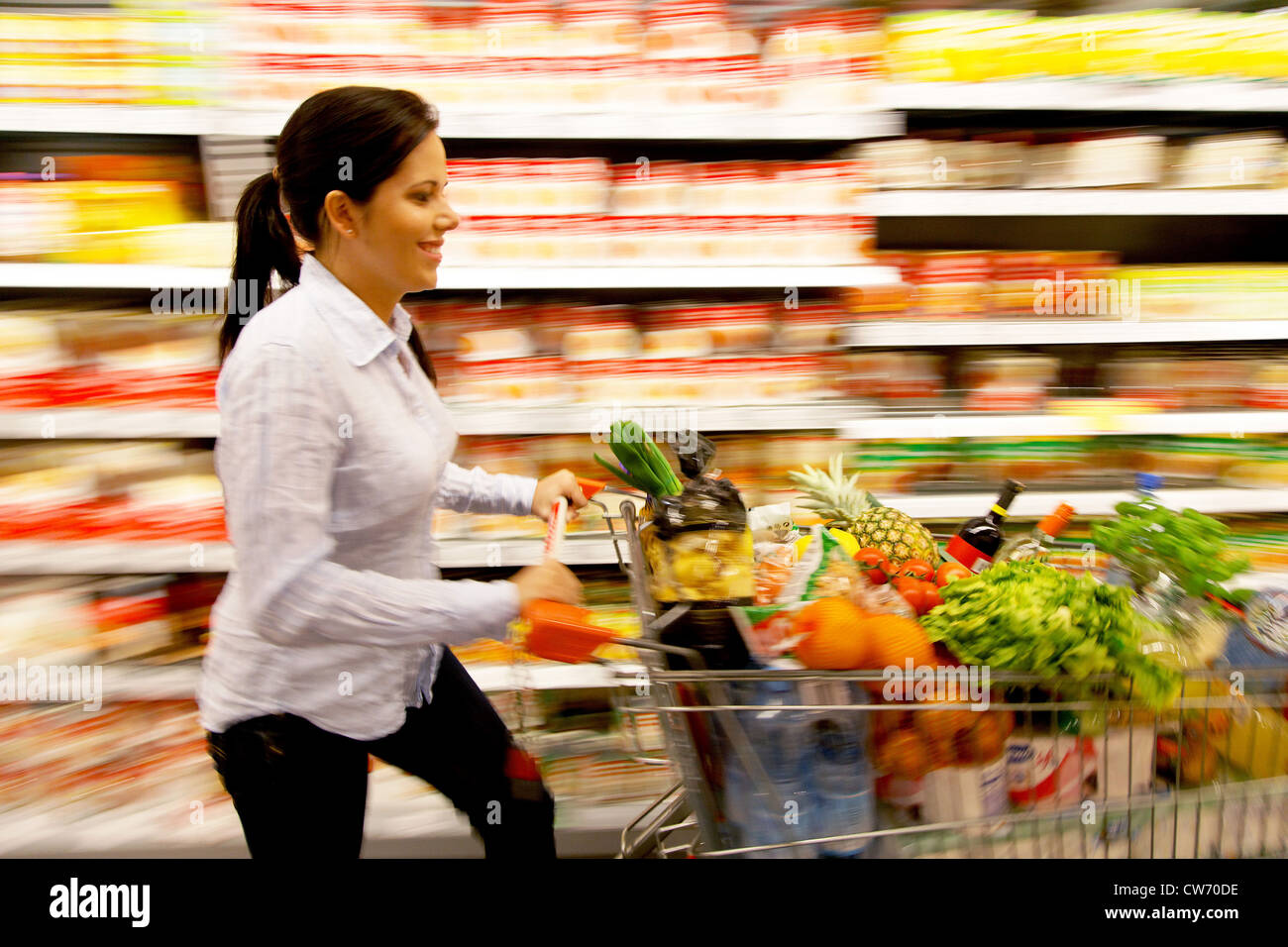 young woman in the supermarket buys food Stock Photo
