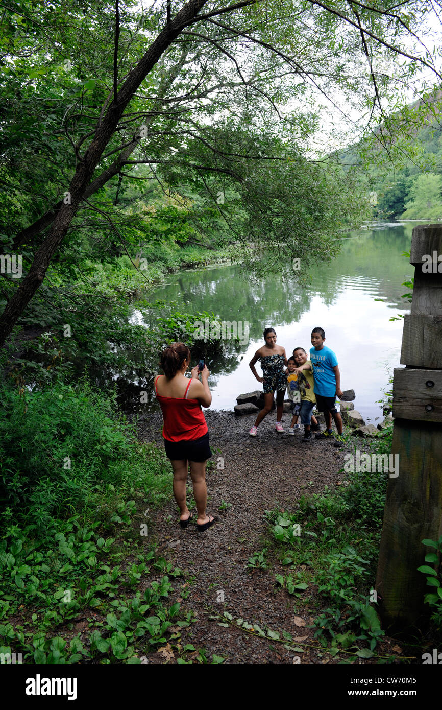 Hispanic American family takes a portrait at the edge of East Rock Park on a hot afternoon. Stock Photo