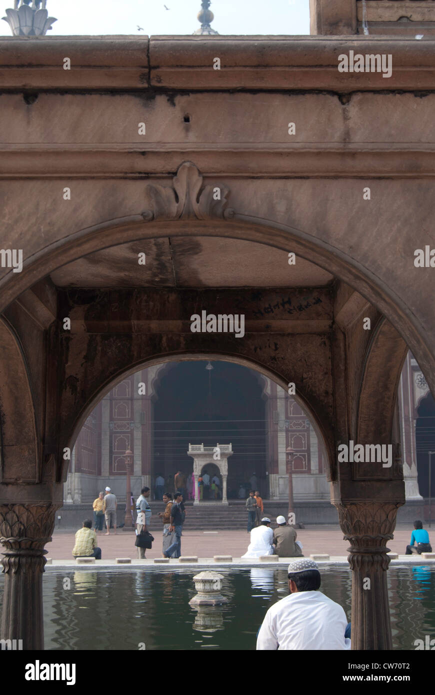 Pool of water inside the Jama Masjid in Delhi. Can see Muslim men and ...