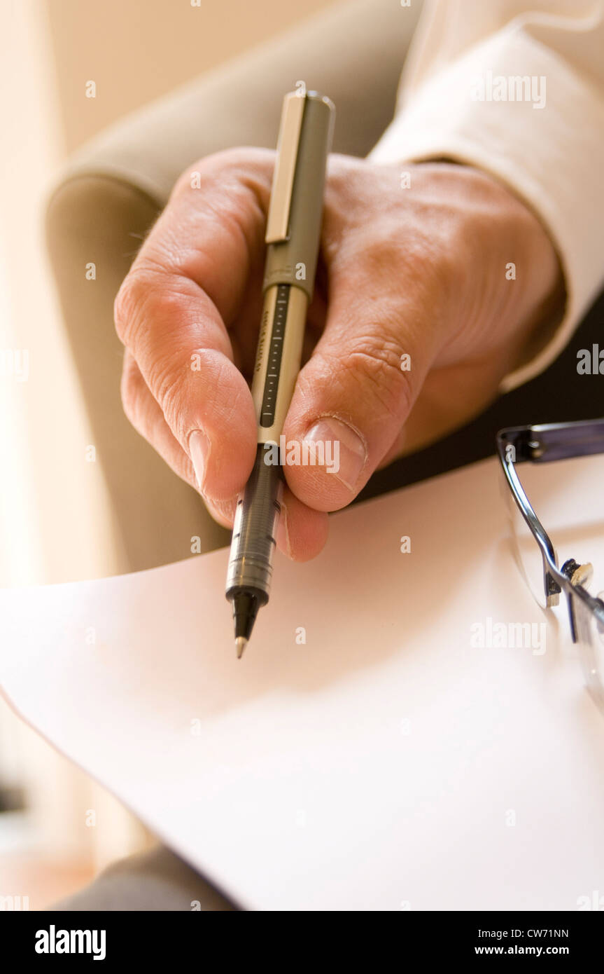 taking notes in business meetings meeting note write writing jot jotting down pen hand Stock Photo