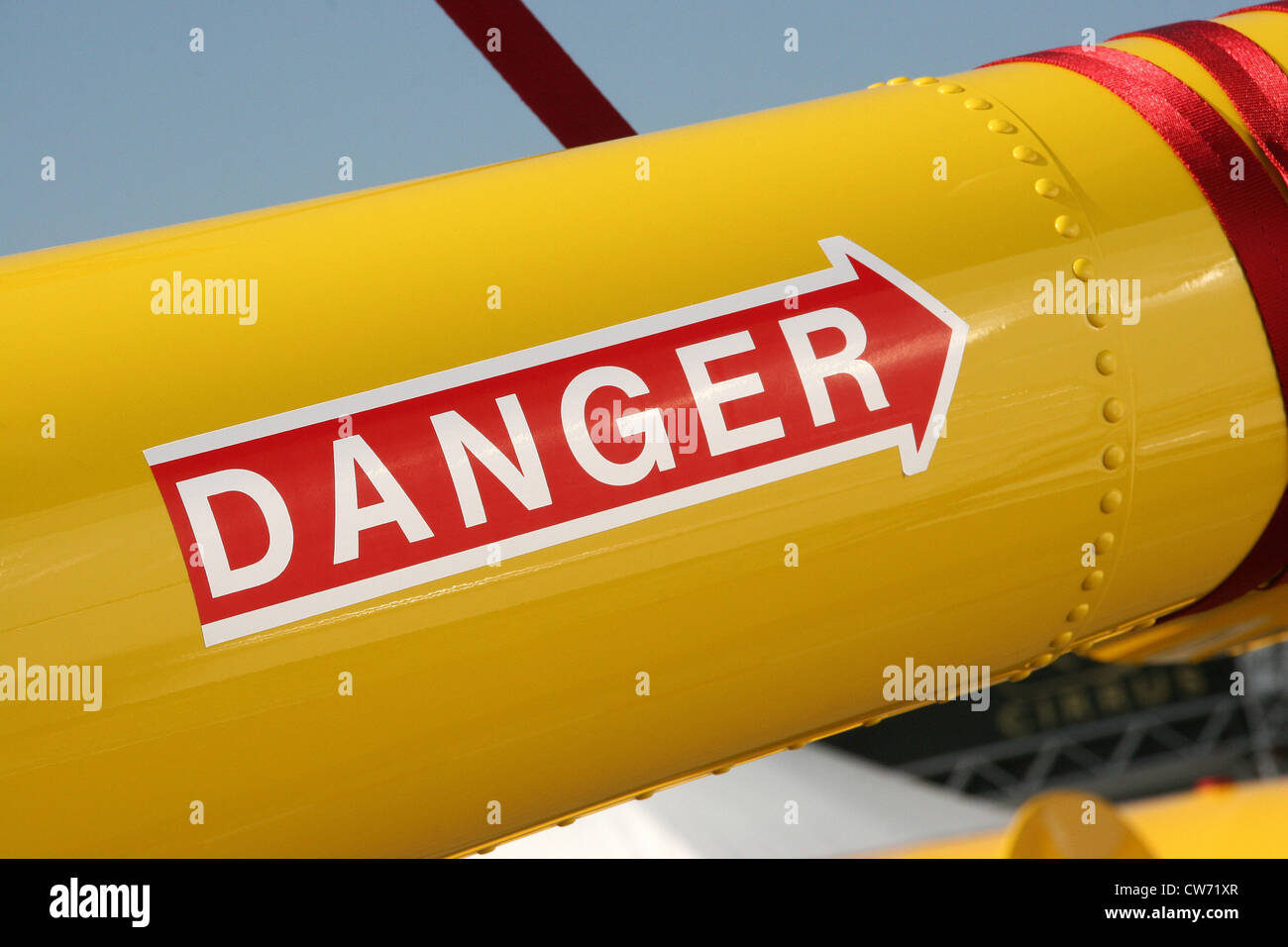 metal tube with an arrow on it pointing upwards with the writing 'DANGER' Stock Photo Alamy