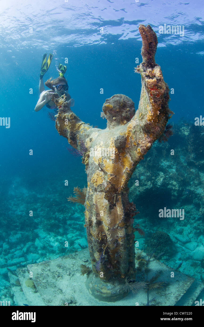 Snorkeler reaches out to Statue of Christ of the Abyss Stock Photo
