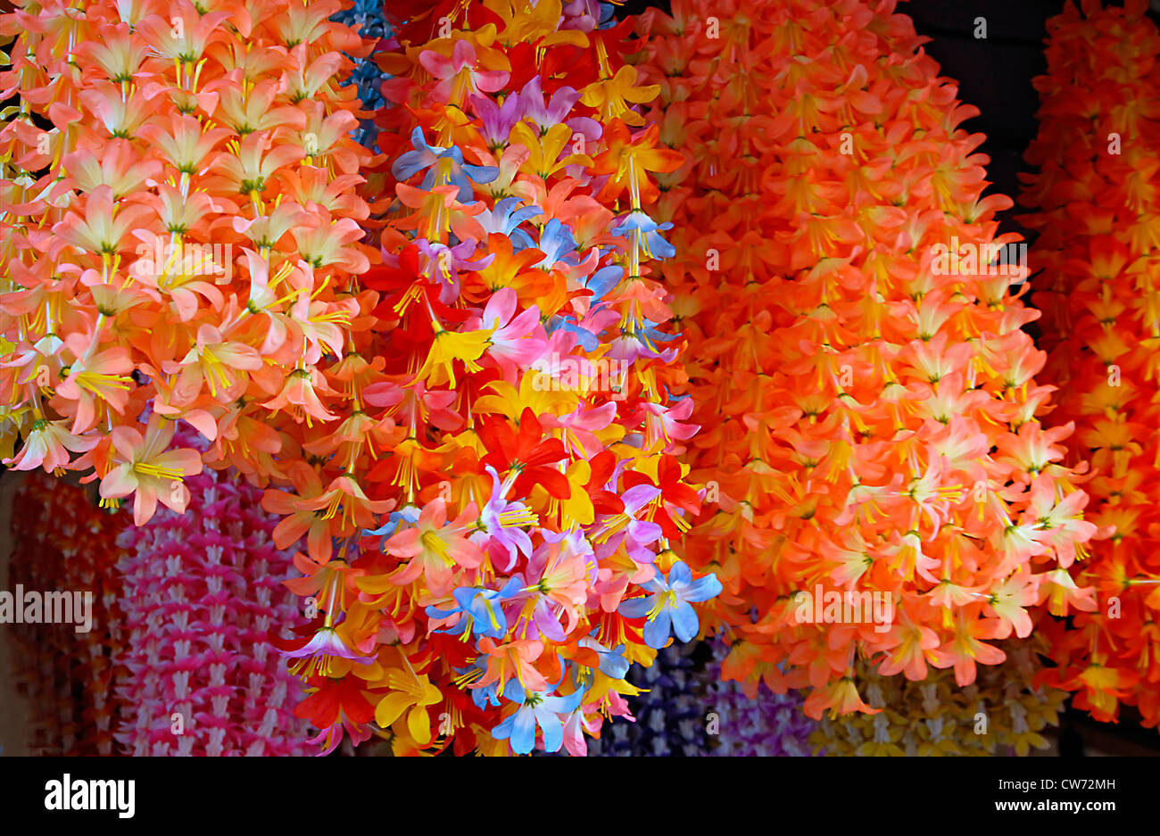 typical Indian flower decoration made of plastic flowers and in all kind of colors. The flowers are normally used for flower offerings in Hindu Temples, India Stock Photo