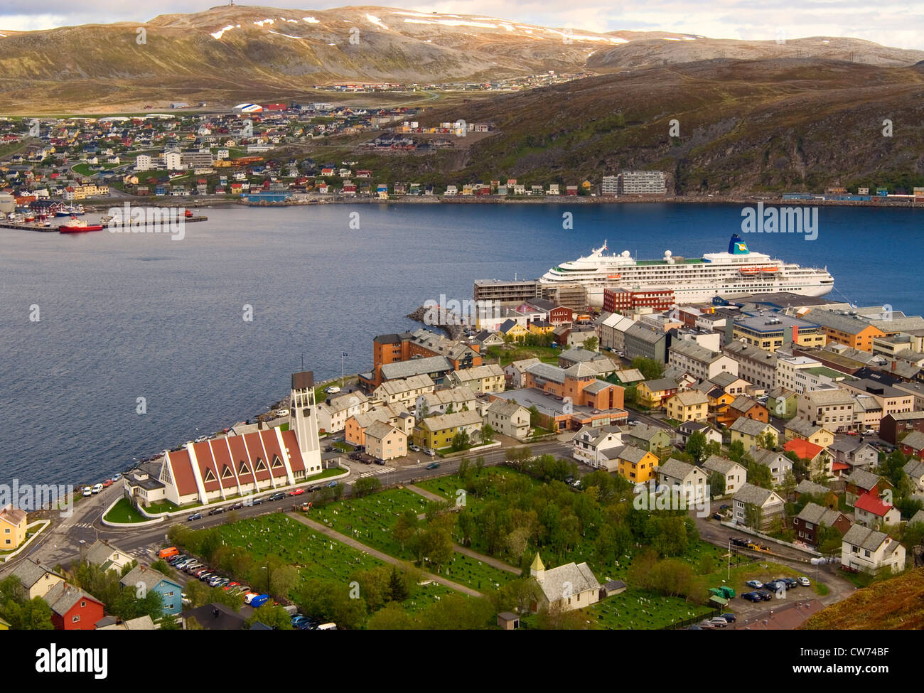 fishing boats and colorful houses in the harbor of Hammerfest in the