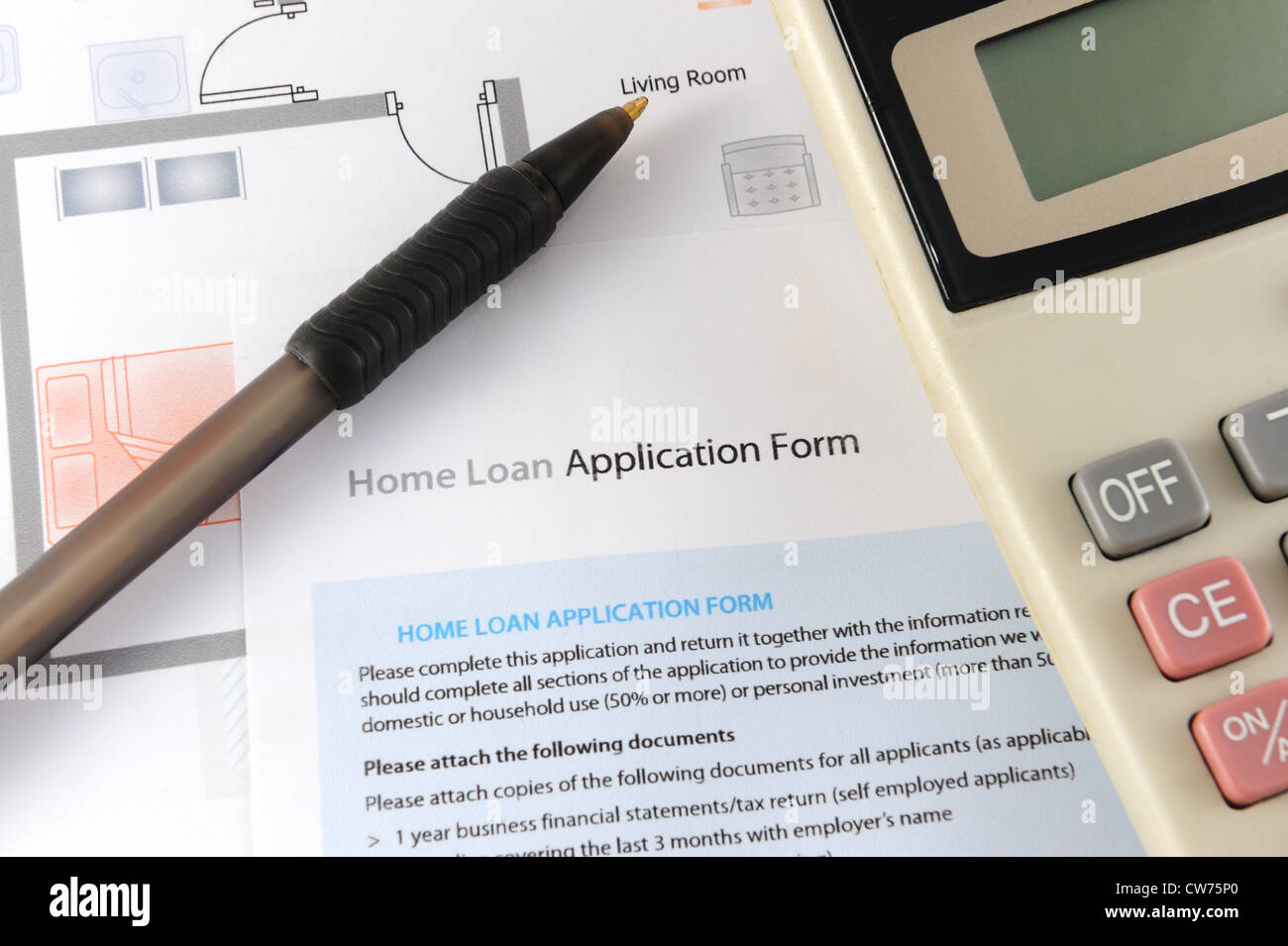 Home loan application form with calculator and pen nearby Stock Photo