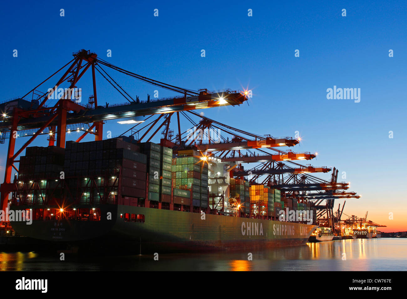 cotainer ship in Port of Hamburg at sunset, Germany, Hamburg Stock Photo