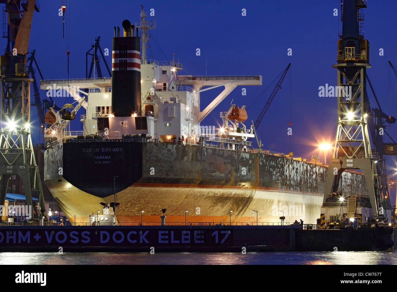 container ship in Port of Hamburg at night, Germany, Hamburg Stock Photo