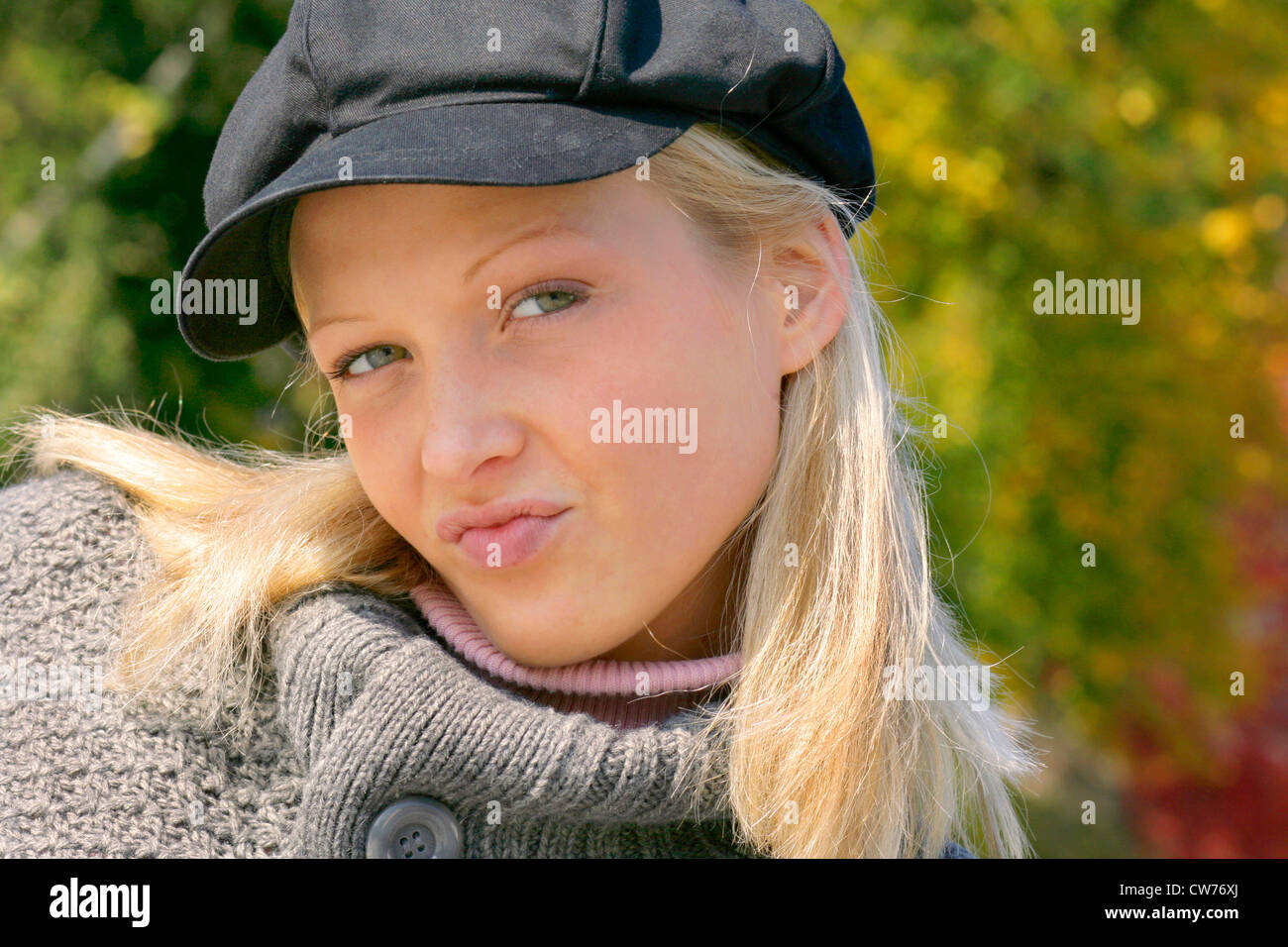 young blond sulky girl with cap Stock Photo