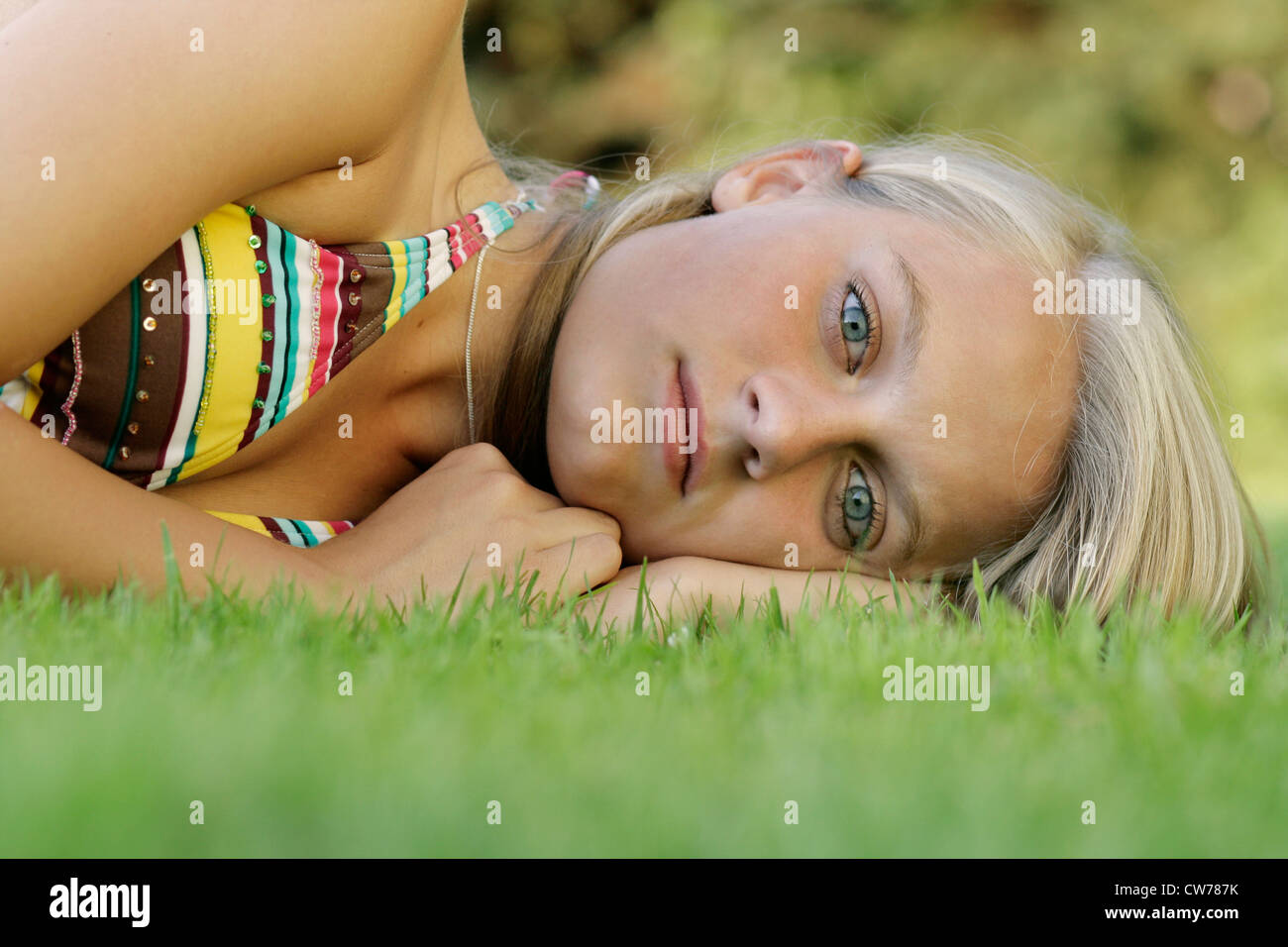 young girl in bikini, lying on a meadow Stock Photo - Alamy