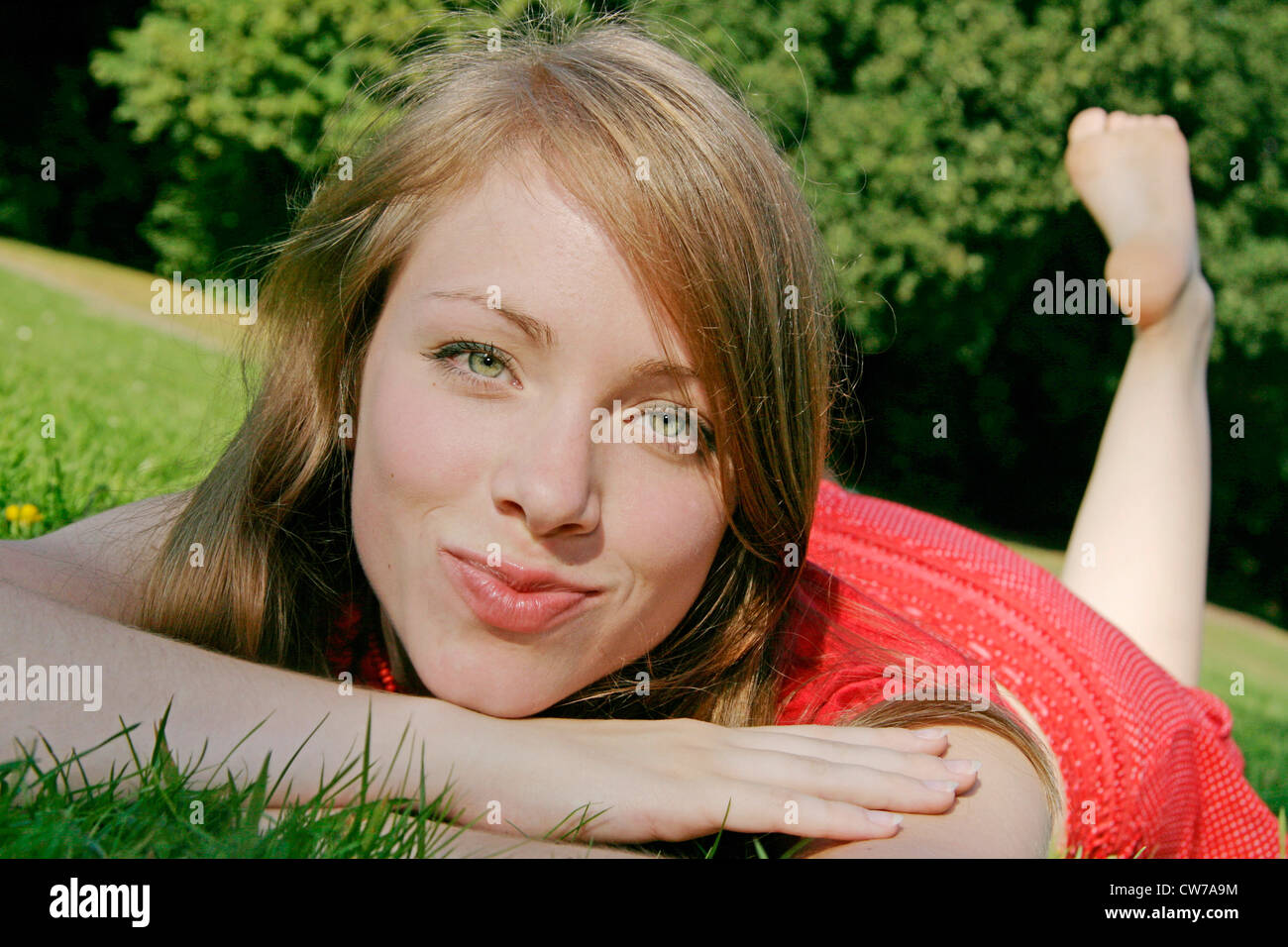 young woman lying in meadow, Germany Stock Photo