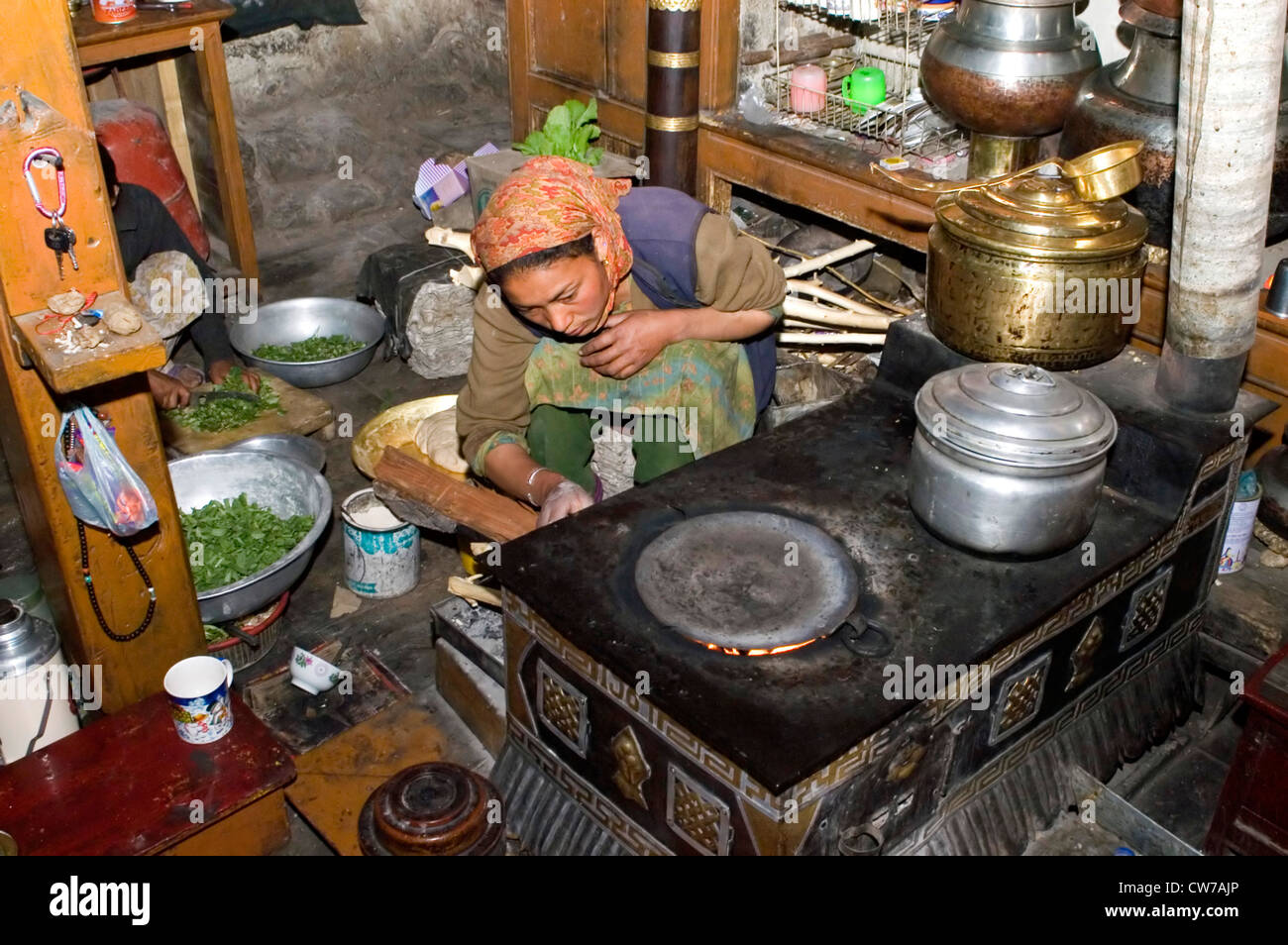 woman baking chapatis in the kitchen, Nurla, Indus valley, India