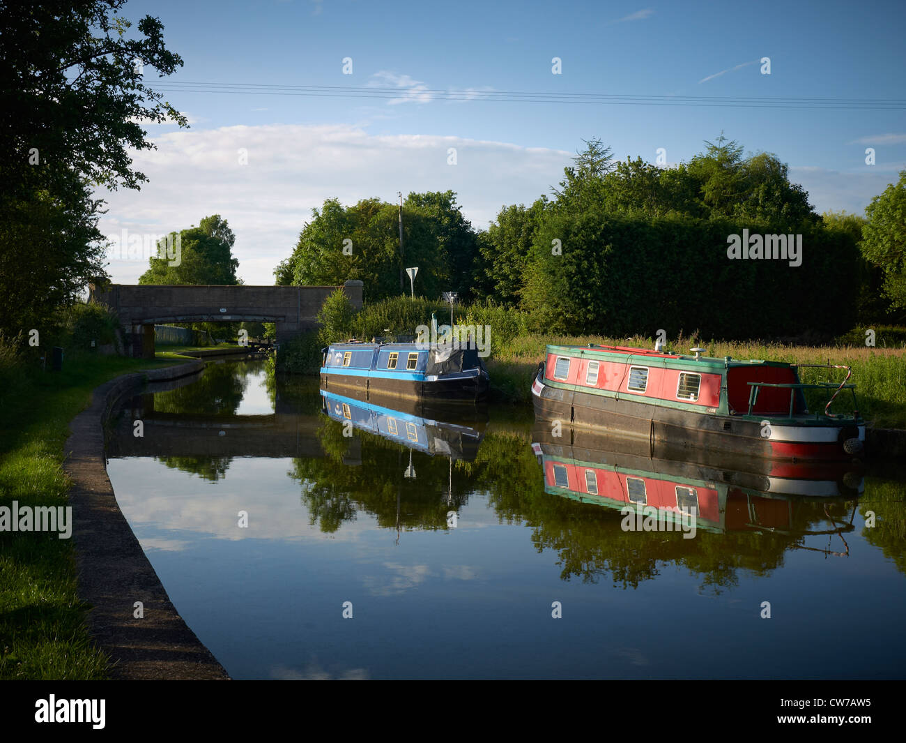 Narrowboat, in evening sun, on the Trent and Mersey Canal near Elworth Cheshire UK Stock Photo
