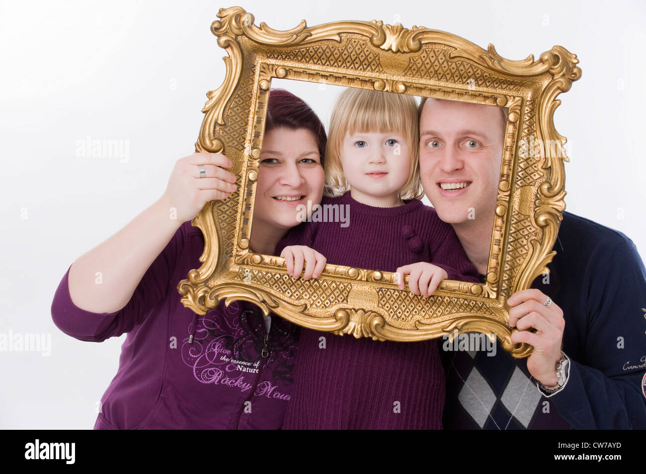 parents with daughter with picture frame Stock Photo Alamy
